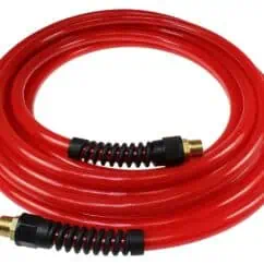 Flexible red hydraulic hose with brass fittings and protective coil sleeve, used for fluid transfer in industrial and hydraulic systems.