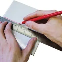 Cutting tools with ruler and pencil for precise measurements, engineering or design work, NIS Tools logo in background.