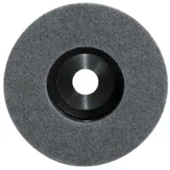 Grinding wheel for metal cutting and finishing, with a dark abrasive surface and central mounting hole, ideal for industrial and manufacturing applications.