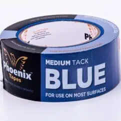 Blue adhesive tape with branding for surface applications, labeled "Medium Tack Blue" for use on most surfaces.