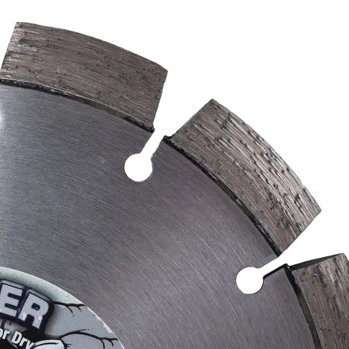 High-resolution close-up image of a circular saw blade with sharp teeth, used for precision cutting in woodworking and construction. The blade features metallic teeth and a smooth, circular body.