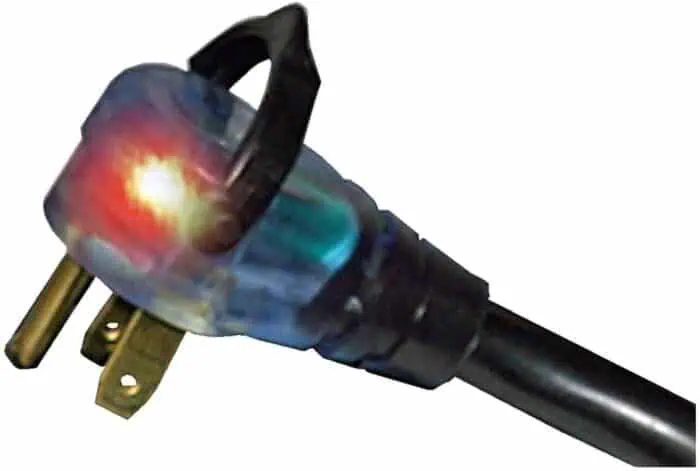 Power plug with glowing illuminated tip for electrical testing, close-up of electrical socket adapter, showcasing safety and power connection tools, ideal for electrical diagnostics and troubleshooting.