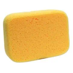Yellow cleaning sponge with orange scrubber side for kitchen and household cleaning tasks.