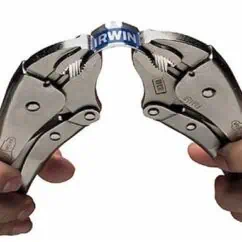 Heavy-duty locking pliers gripping a small, blue pipe clamp for industrial or plumbing fastening tasks, showcasing precision tool handling and durable construction.