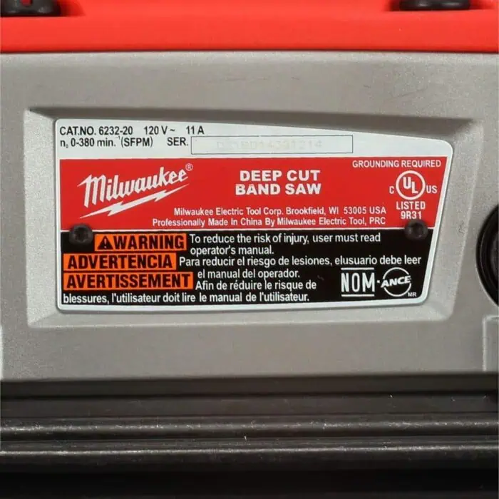Milwaukee deep cut band saw safety label with warning instructions, certification marks, and manufacturer details for professional power tools.