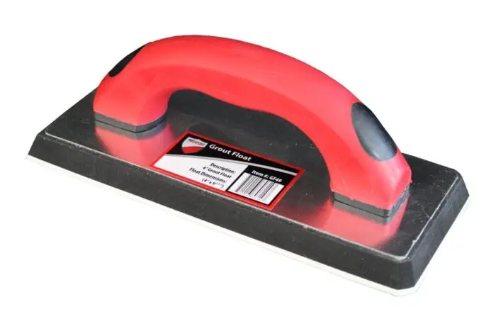Red handheld grout float with black base for tile grout application, ergonomic design for professional masonry and tiling work.