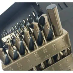 Hardened steel drill bits organized in a storage rack, featuring various sizes labeled for precision drilling, essential for industrial and manufacturing applications.