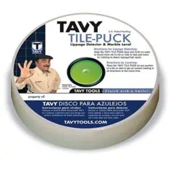 Tavy tile-puck lippage detector and marble level for tile installation, with professional man demonstrating its use on white background.