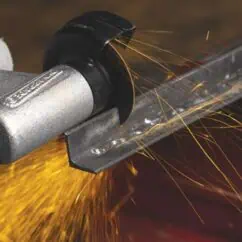 High-precision industrial plasma cutting tool in action, producing bright sparks on metal surface for accurate fabrication and manufacturing applications.