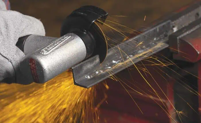 High-precision industrial plasma cutting tool in action, producing bright sparks on metal surface for accurate fabrication and manufacturing applications.