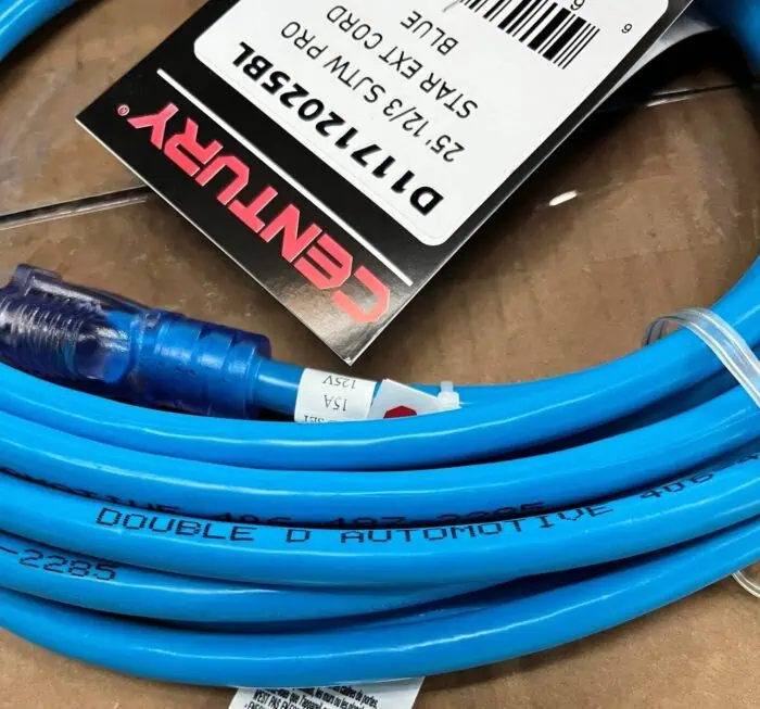 Blue automotive air hose with quick-connect fittings and safety tag, labeled "Double D Automotive.".
