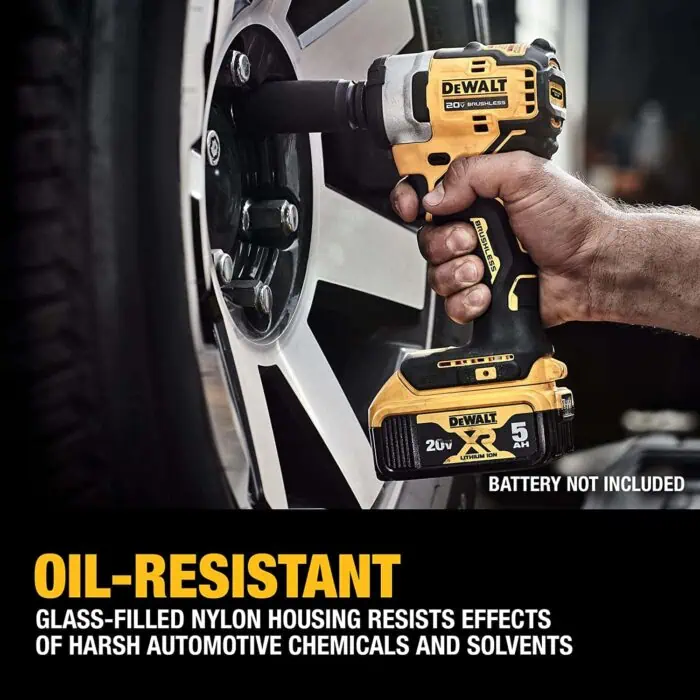 DeWalt cordless impact driver working on a car wheel with a black tire and silver rim, showcasing power tools used in automotive maintenance.