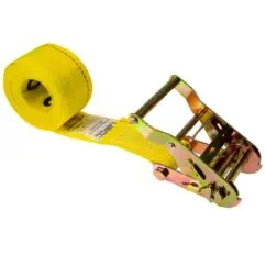 High-strength yellow ratchet strap with metal locking mechanism, used for securing heavy loads during transportation on trucks and trailers.